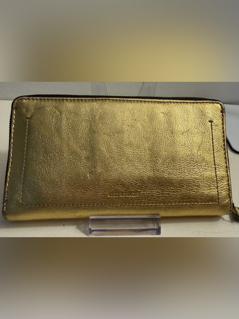 Reed Krakoff gold metallic leather wallet.